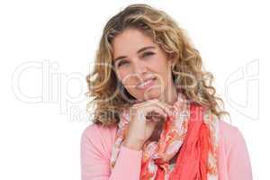 Smiling blonde woman posing with her hand on her chin