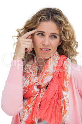 Blonde woman pointing her temple