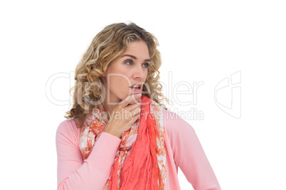 Blonde thoughtful woman posing while touching her chin