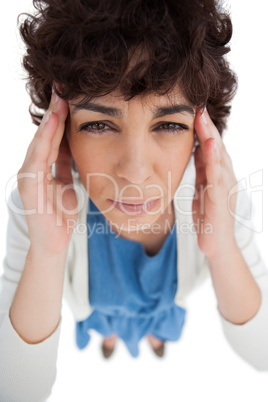 Overhead of woman with a headache touching her temples