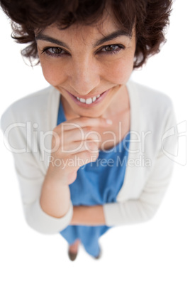 Overhead of cheerful woman with hand touching her chin