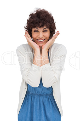 Astonished brunette woman standing and smiling