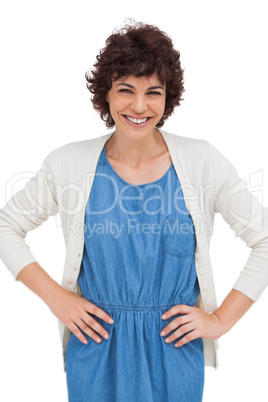 Smiling brunette woman placing hands on hips