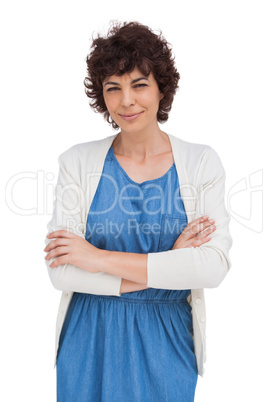 Smiling brunette woman with arms folded