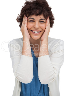 Surprised brunette woman holding her head between hands