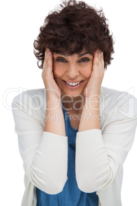 Astonished brunette woman holding her head between hands