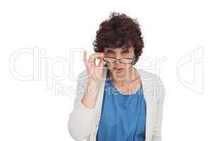 Shocked woman looking over her glasses