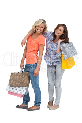 Two friends holding shopping bags