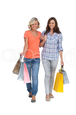 Two cheerful friends with shopping bags