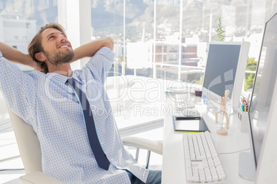 Designer leaning back at his desk