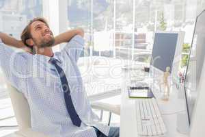 Designer leaning back at his desk