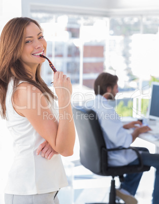 Happy designer biting her glasses