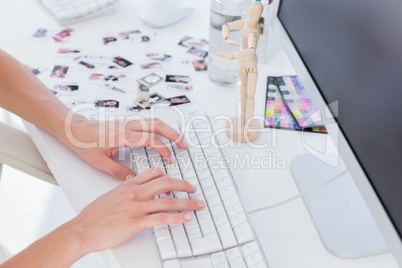 Female editor typing on keyboard