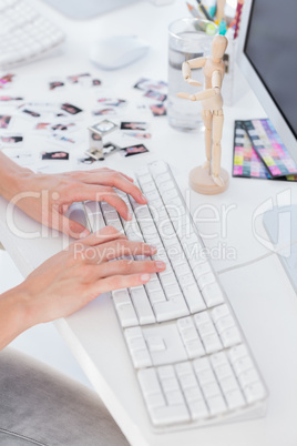 Close up of womans hands typing