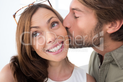 Man giving pretty woman kiss on the cheek