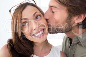 Man giving pretty woman kiss on the cheek