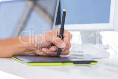 Male hands using a graphics tablet