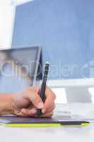 Male hand drawing on graphics tablet