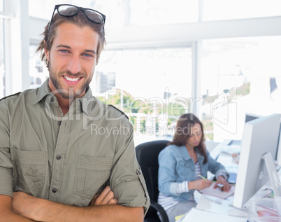 Smiling editor looking at camera with arms crossed