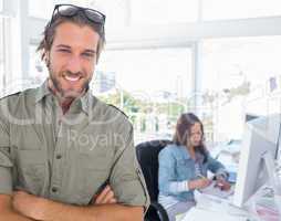 Smiling editor looking at camera with arms crossed