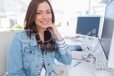 Attractive designer smiling in creative office