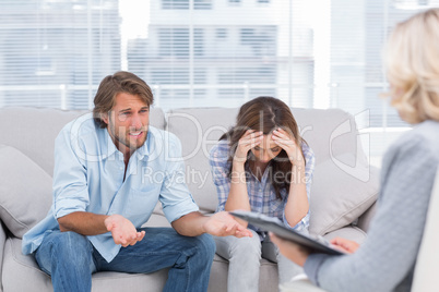 Young couple sit on the couch of the therapist
