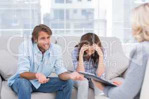 Young couple sit on the couch of the therapist
