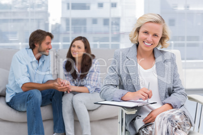 Young couple and therapist looking at the camera