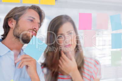 Two colleagues looking at sticky notes