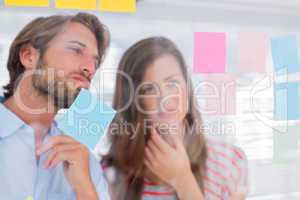 Two colleagues looking at sticky notes