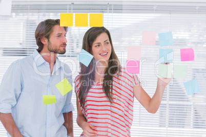 Young man and woman brainstorming together