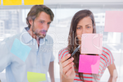 Woman pointing a sticky note