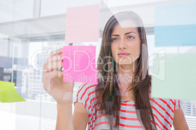 Woman checking sticky note