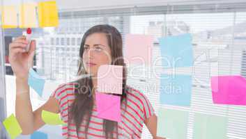 Young woman writing in creative office