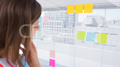 Woman looking at sticky note
