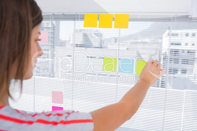 Woman pasting sticky note