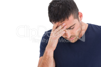 Upset man standing with his hand holding his forehead