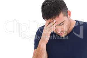 Upset man standing with his hand holding his forehead