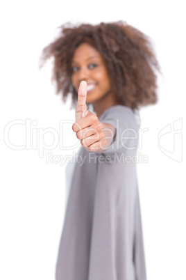 Smiling woman giving her thumb up