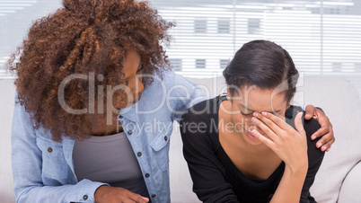 Sad woman crying next to her therapist