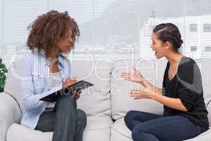 Upset woman speaking to her therapist