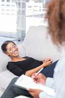 Woman laughing on sofa during therapy session