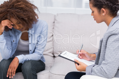 Woman sitting on sofa at therapy