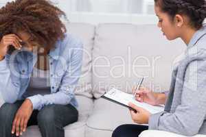 Woman sitting on sofa at therapy