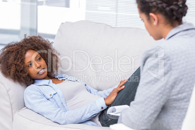 Woman lying on sofa and speaking to her therapist