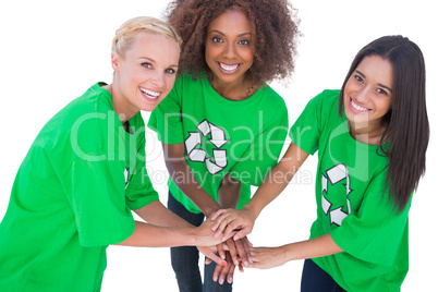 Three enviromental activists putting their hands together and sm