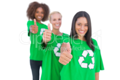 Three smiling enviromental activists giving thumbs up