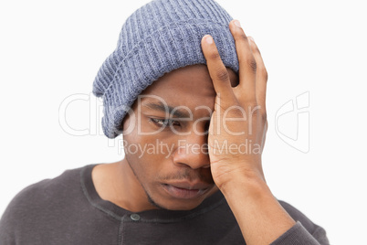 Depressed man in beanie hat