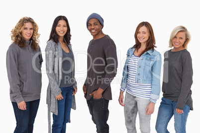 Fashionable young people in a line smiling