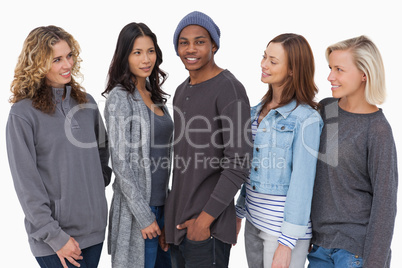 Fashionable young people in a row all looking at man